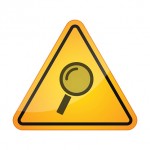 Danger signal icon with a magnifier