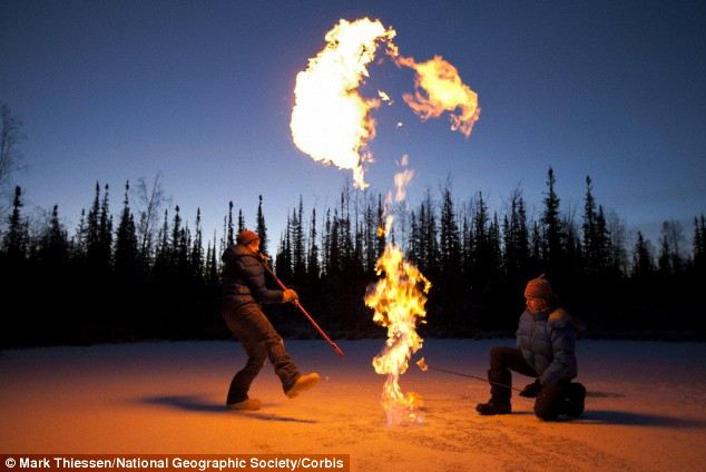 An ecologist ignites a large methane bubble that was trapped by the autumn freeze. One of the largest concerns about thawing permafrost is the sudden release of methane from the Arctic